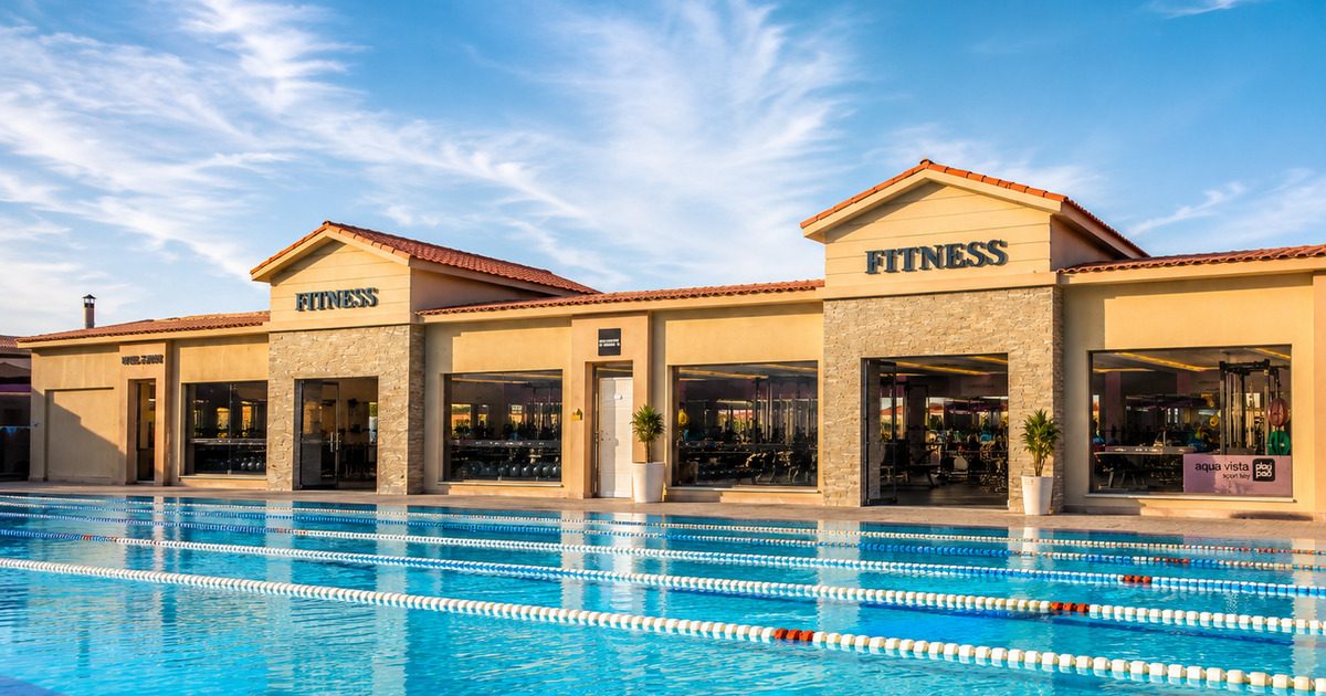 Outdoor Olympic-length swimming pool with two dedicated fitness centre buildings alongside, Aqua Vista resort Hurghada